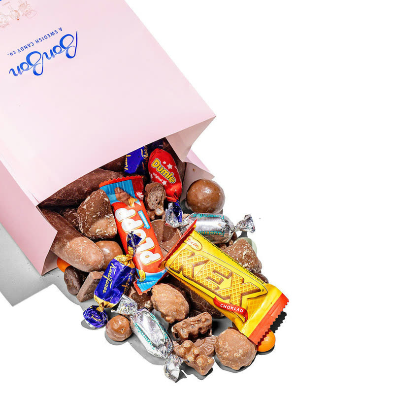 A pink BonBon candy bag spilling Chocolate Mix