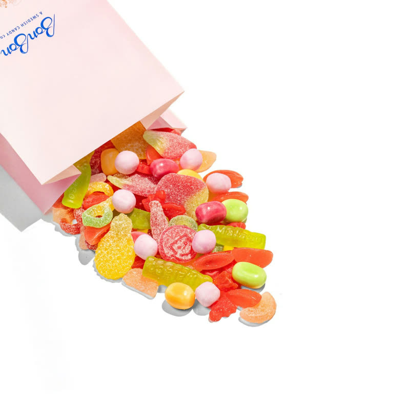 A pink BonBon candy bag spilling Sour & Sweet Gluten-Free Mix